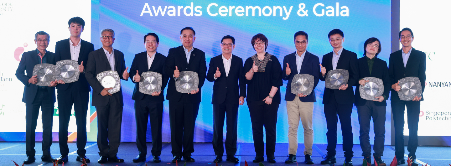 A group of people hold awards at an "Awards Ceremony & Gala".